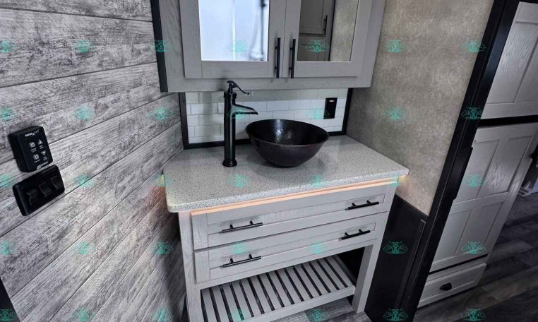 Grey bathroom vanity with mirrored medicine cabinets above a speckled countertop and a black vessel sink; a white toilet is in the foreground.