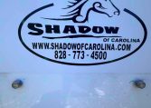 Oval Shadow of Carolina logo with a stylized horse head, website www.shadowofcarolina.com and phone 828-773-4500 on a blue trailer surface.